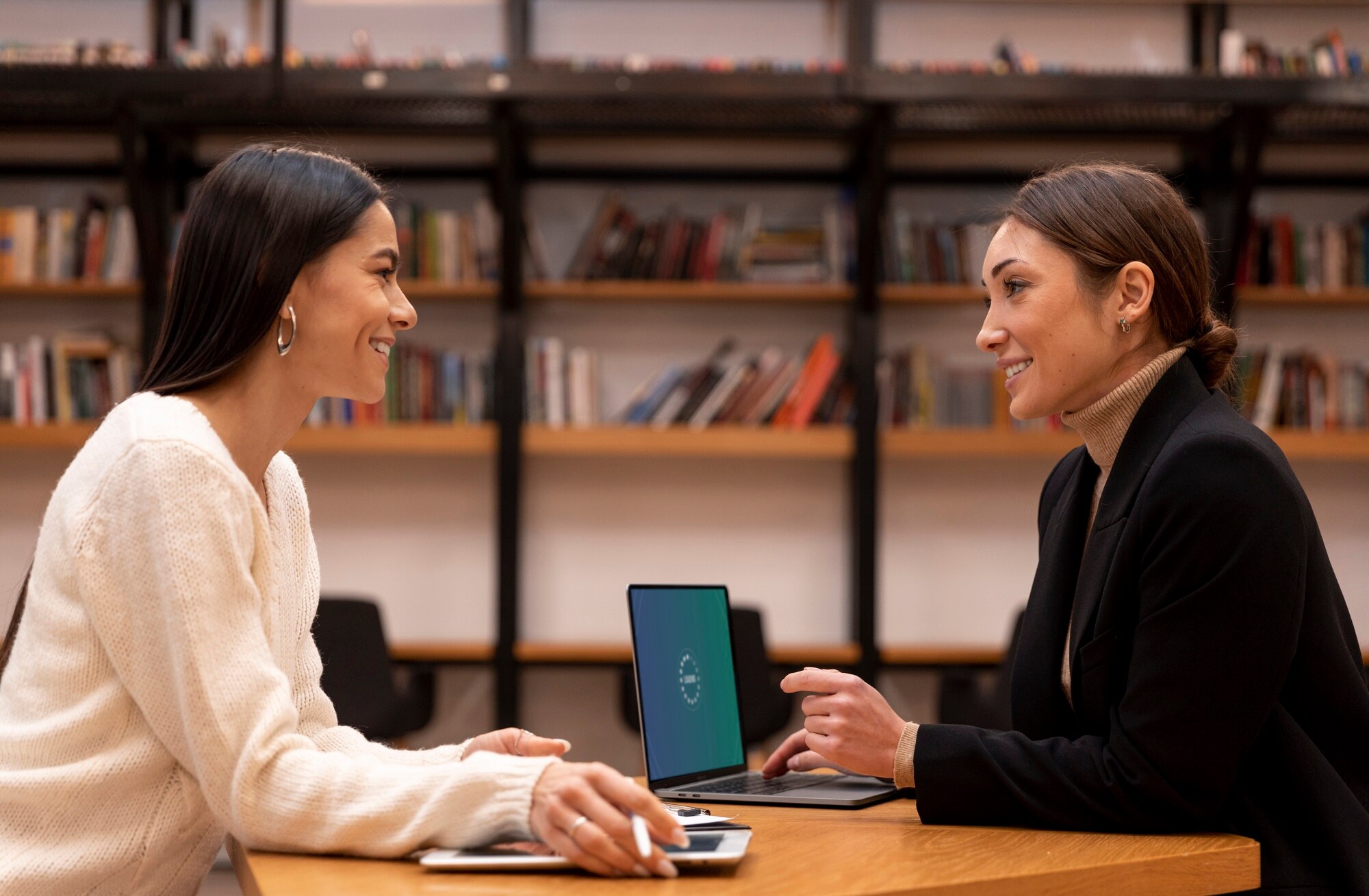Manager having a one-on-one conversation with team members in an office setting