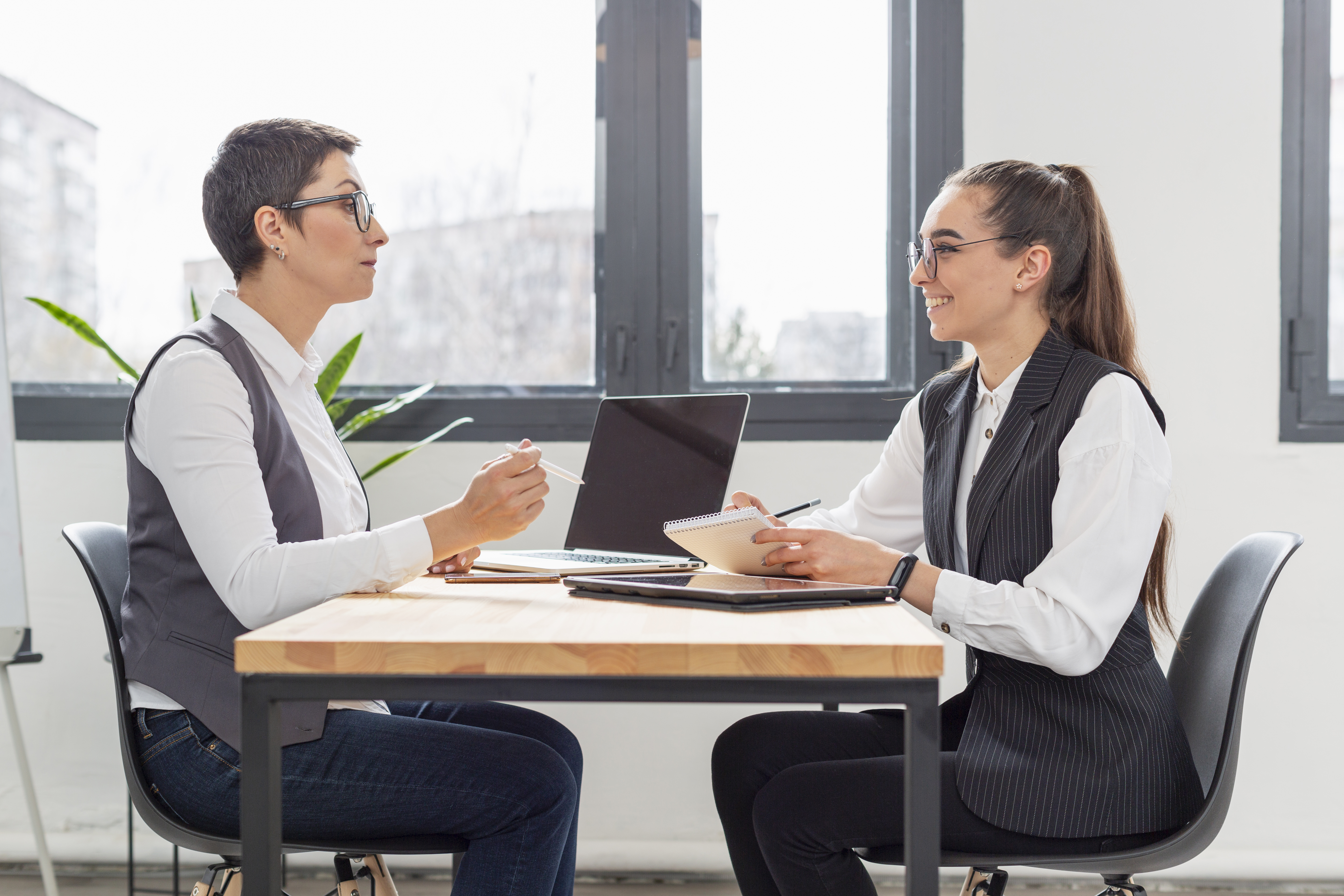 Adult woman employee having a one-on-one meeting with her manager