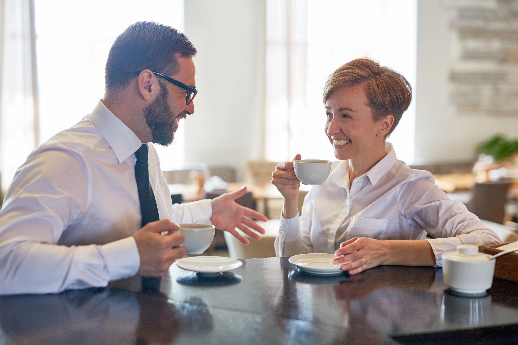 Team members having coffee with each other